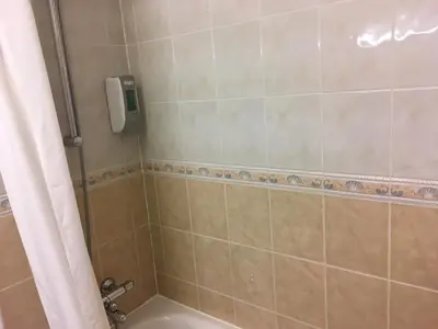a bathroom with a shower with a tub and a toilet at Moreton Park Hotel in Chirk