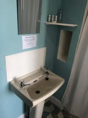 a bathroom with a sink and a mirror at The Sandpiper in Barmouth