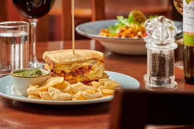 a sandwich and chips on a plate on a table at The Glengower in Aberystwyth