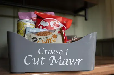 a gift box with food in it on a table at Cegir Escapes in Darowen