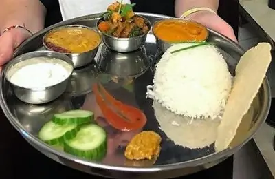 a tray of food with rice and vegetables on it at New Gurkha Inn in Brecon