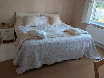 a bedroom with a bed with two pillows on it at Hazler Lodge guest house in Church Stretton