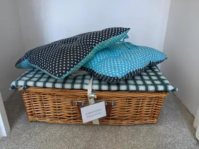 a basket with three pillows on top of it at Hazler Lodge guest house in Church Stretton