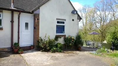 a white house with a white door and some plants at Hazler Lodge guest house in Church Stretton