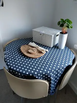 a table with a blue and white polka dot table cloth at Hazler Lodge guest house in Church Stretton
