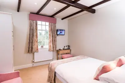 a bedroom with two beds and a window at The Swan At Hay in Hay-on-Wye