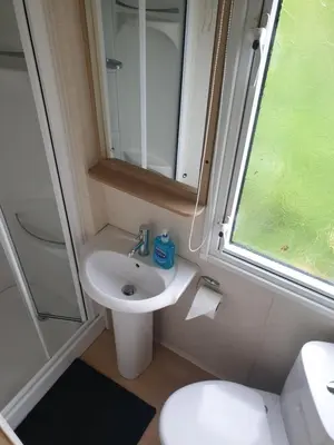 a small bathroom with a sink and a toilet at Sea retreat caravans in Aberystwyth
