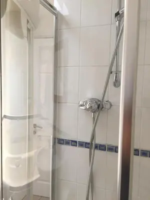 a shower with a glass door in a bathroom at March Cottage Brecon in Brecon