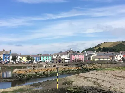 a town with a bridge over a body of water at The Bakery in Llanddeiniol