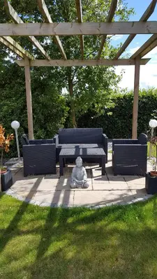 a statue sitting next to a table and chairs at Ruth's Rest Country Retreat with private Hot Tub & Views of Open Countryside in Shrewsbury