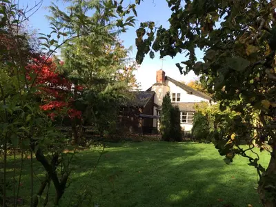 a house with a yard with green grass at Yew Tree Cottage in Leominster