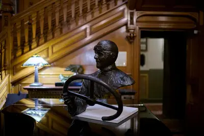 a statue of a man sitting on a desk at Palé Hall in Bala