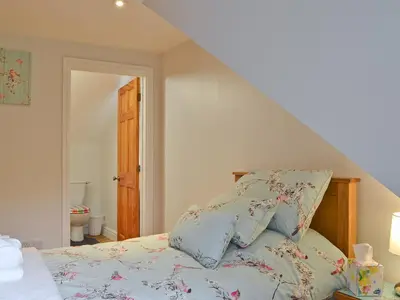a bedroom with a bed with pillows on it at Dyffryn Haidd in Llanafan