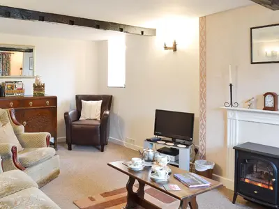 a living room with a tv and a fireplace at Upper Ffinnant in Aber-Brân