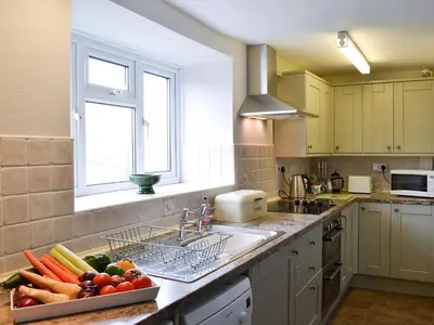 a kitchen with a bowl of vegetables on the counter at Upper Ffinnant in Aber-Brân
