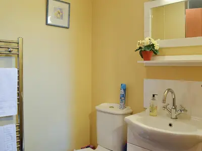 a bathroom with a toilet and a sink at Chalgrove in Aber-Brân