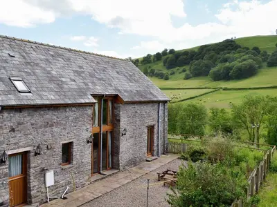 a stone house with a view of the countryside at Chalgrove in Aber-Brân
