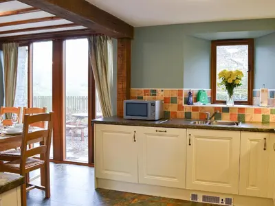 a kitchen with a sink and a microwave on a counter at Chalgrove in Aber-Brân