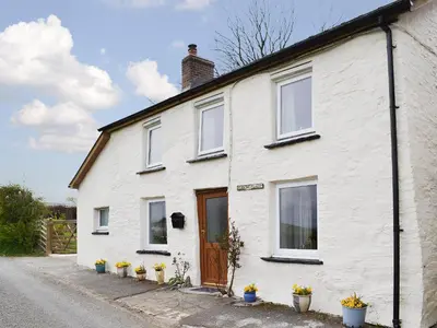 a white house with white windows and a door at Bryntrisant in Devils Bridge