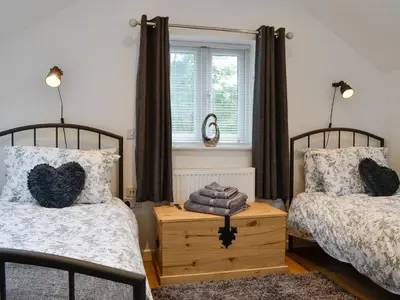 a bedroom with two beds and a window at Bryn Aled in Llanfachreth