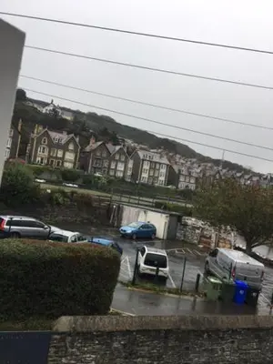 a view of a parking lot with cars and houses at Llys y Dderwen - Oak Court in Aberystwyth