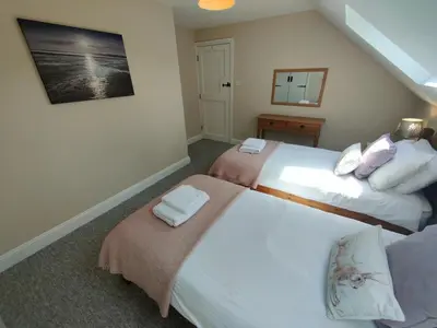 a bedroom with two beds with towels on them at Pant Glas Barn in Llanbrynmair