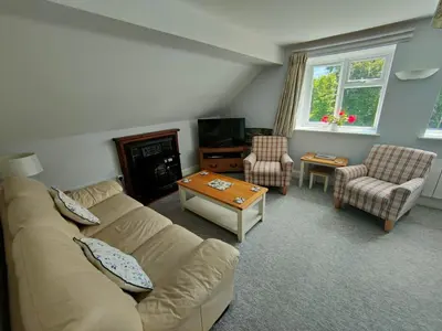 a living room with a couch and a table at Pant Glas Barn in Llanbrynmair