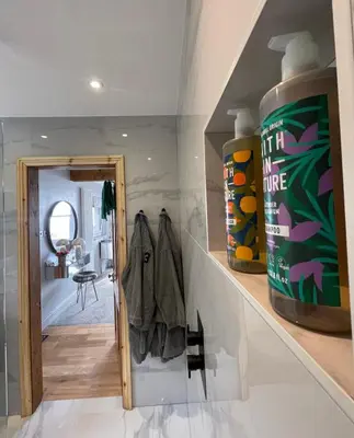 a room with a hallway with a mirror and a door at Brig-y-Don in Aberdyfi