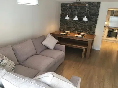 a living room with a couch and a table at Riverside Suites Llangollen in Llangollen