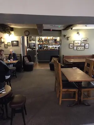 a restaurant with tables and chairs and a bar at Church Inn in Ludlow