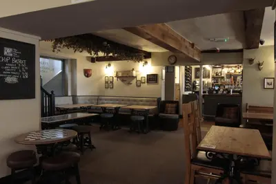 a restaurant with tables and chairs and a bar at Church Inn in Ludlow