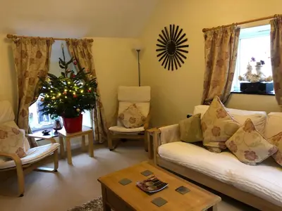 a living room with a couch and a table at Bryn Melyn Farm Cottages in Bala