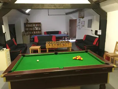 a living room with a pool table and couches at Bryn Melyn Farm Cottages in Bala