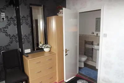 a bathroom with a toilet and a sink at Hillcrest Guest House in Llangollen
