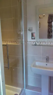 a bathroom with a shower and a sink at Hillcrest Guest House in Llangollen