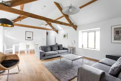 a living room with a couch and a table at Owl Barn at Penygaer Great views of Brecon Beacons in Llandovery