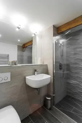 a bathroom with a sink and a shower at Owl Barn at Penygaer Great views of Brecon Beacons in Llandovery