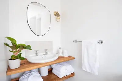 a bathroom with a sink and a mirror at Granary Cottage with hot tub on organic farmland in Lampeter