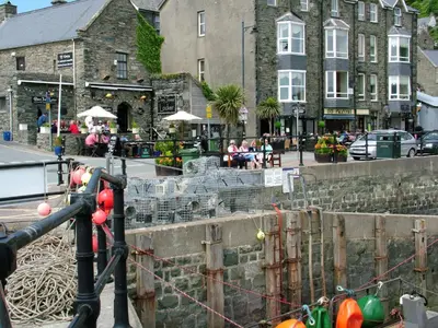 a group of people sitting outside a building at Sunray Suites in Barmouth