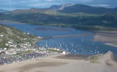an aerial view of a beach with boats in the water at Sunray Suites in Barmouth