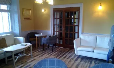 a living room with a couch and a table at Tower Hotel in Talgarth