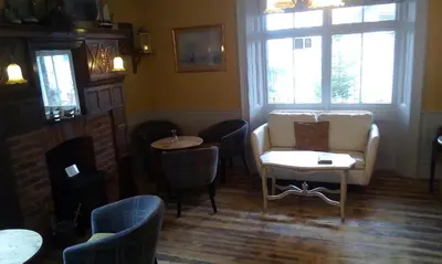 a living room with a couch and a table and chairs at Tower Hotel in Talgarth