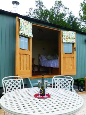 a table and chairs on a patio with a house at Hay-on-Hye retreat in Hay-on-Wye