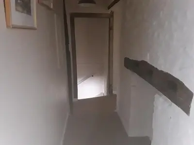 a stairway with a window in a white room at 6 Bridge St. in Brecon
