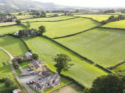 an aerial view of a house in the middle of a field at Pwllgwilym B & B in Builth Wells