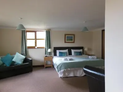 a hotel room with a bed and a couch at Pwllgwilym B & B in Builth Wells