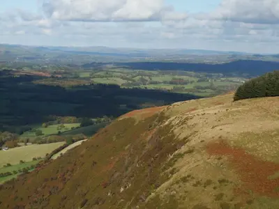 a grassy hill with a view of a valley at Pwllgwilym B & B in Builth Wells