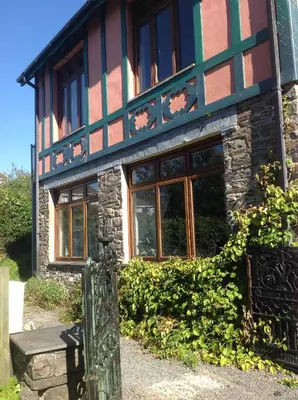 a house with a bench in front of it at Maescelyn in Aberystwyth