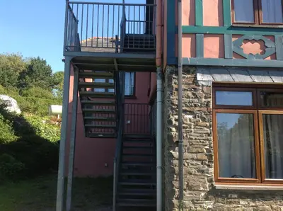 a spiral staircase on the side of a building at Maescelyn in Aberystwyth