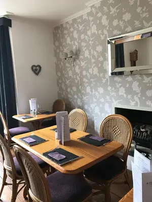 a dining room with two tables and chairs at Ty Mawr Hotel in Llanbedr